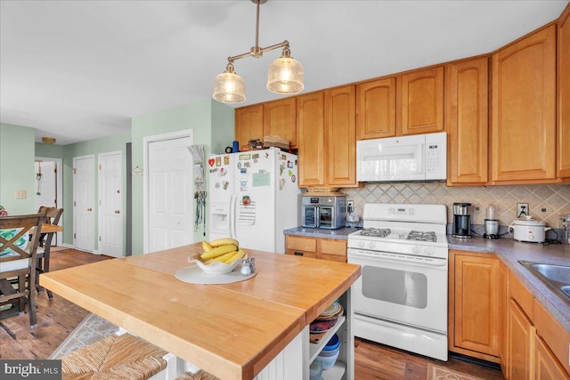 kitchen with white appliances, wood finished floors, open shelves, decorative light fixtures, and tasteful backsplash