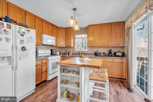 kitchen featuring white appliances, visible vents, light countertops, light wood-style floors, and tasteful backsplash