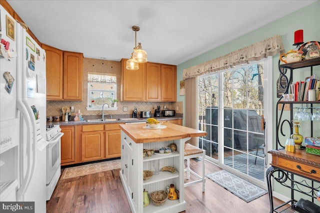 kitchen with butcher block countertops, light wood-style flooring, a sink, open shelves, and white appliances