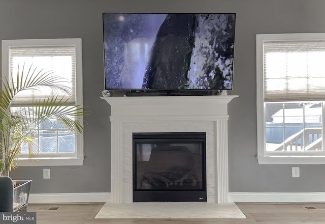 room details featuring a fireplace, visible vents, and baseboards