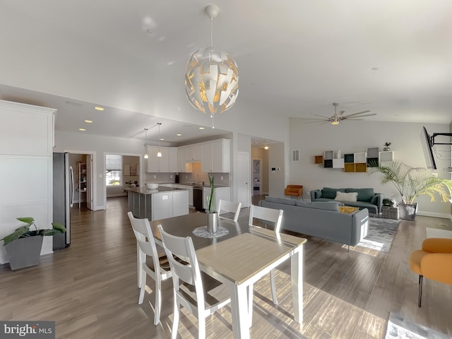 dining room featuring visible vents, baseboards, recessed lighting, ceiling fan with notable chandelier, and wood finished floors