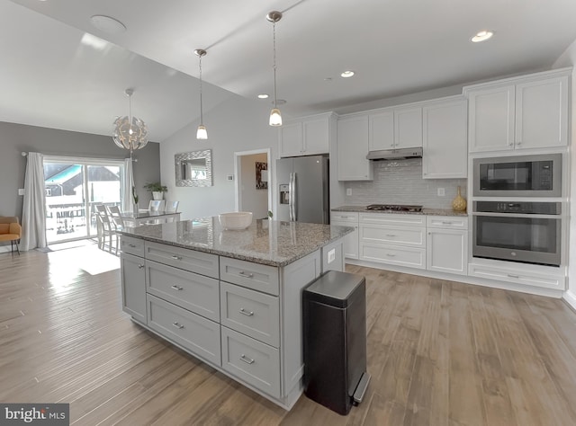 kitchen featuring white cabinetry, appliances with stainless steel finishes, a kitchen island, and light wood-style flooring