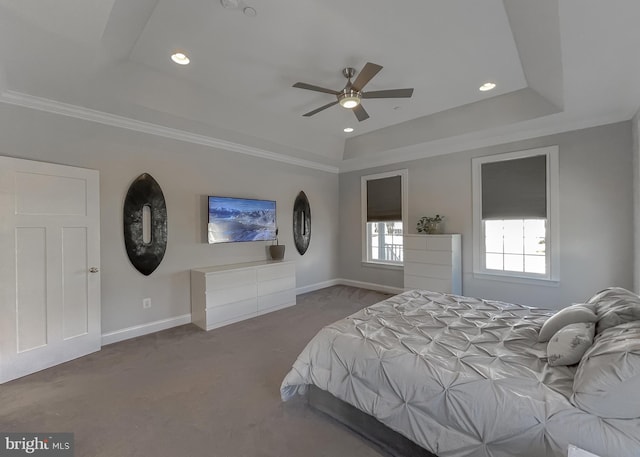 unfurnished bedroom featuring crown molding, baseboards, a tray ceiling, carpet flooring, and recessed lighting