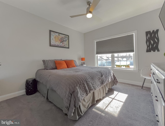 bedroom featuring light colored carpet, baseboards, and ceiling fan