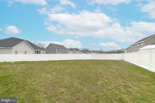 view of yard with a residential view and a fenced backyard