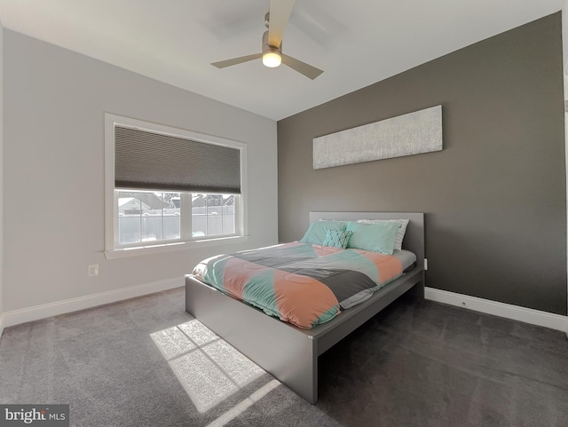 carpeted bedroom featuring baseboards and ceiling fan