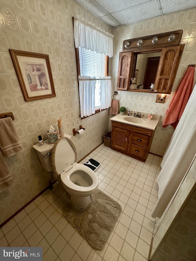 bathroom featuring tile patterned floors, toilet, vanity, and wallpapered walls