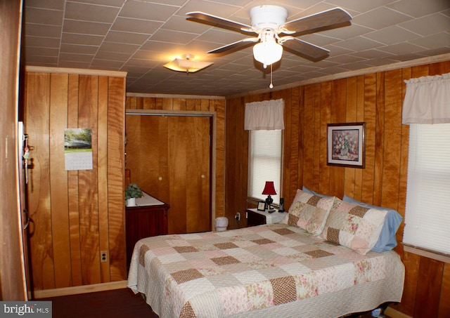 bedroom with a closet and wood walls