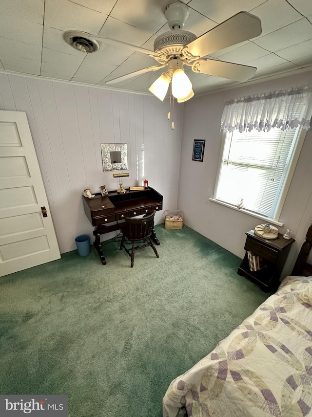 carpeted bedroom featuring crown molding, visible vents, and ceiling fan