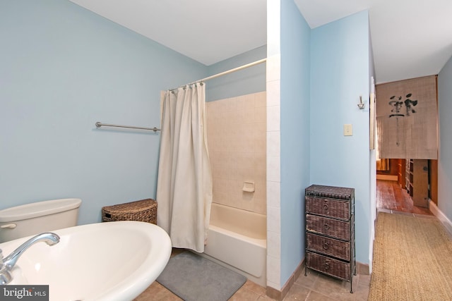 full bathroom featuring a sink, shower / bath combo with shower curtain, and tile patterned floors