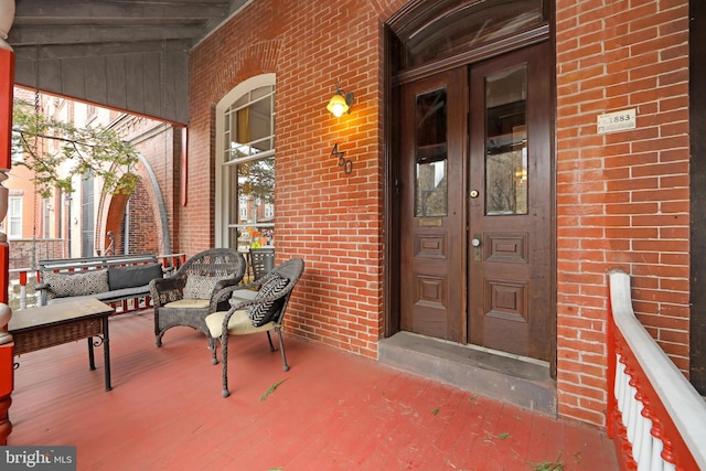 view of exterior entry with french doors and brick siding