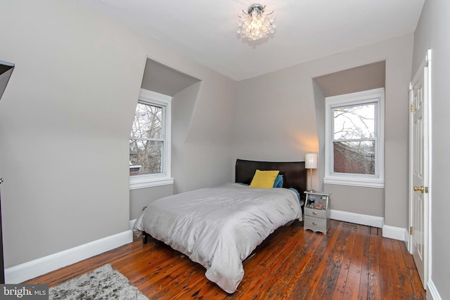 bedroom featuring baseboards and wood-type flooring