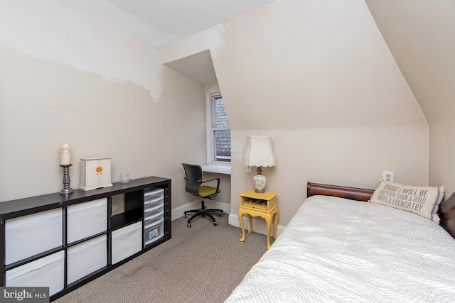 carpeted bedroom featuring baseboards and lofted ceiling