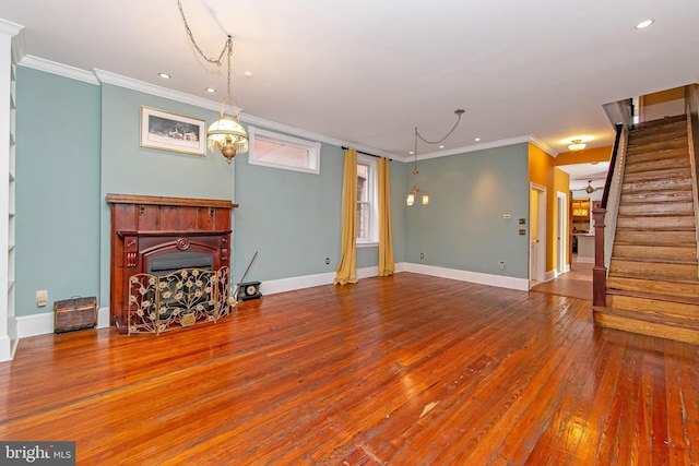 unfurnished living room featuring ornamental molding, hardwood / wood-style floors, stairway, a fireplace, and baseboards