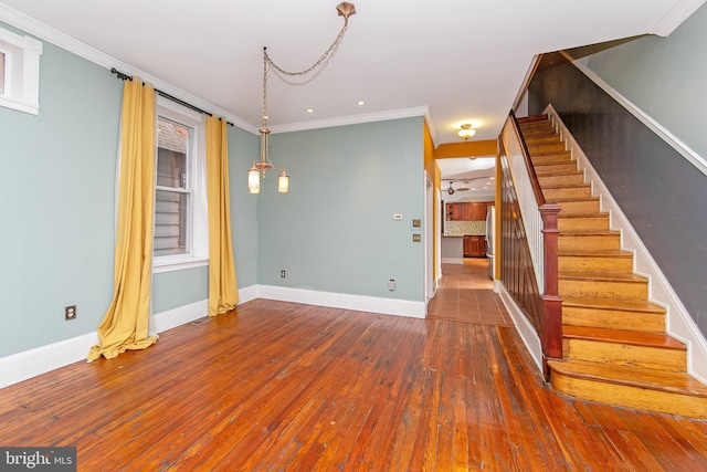 interior space featuring stairs, baseboards, hardwood / wood-style floors, and ornamental molding