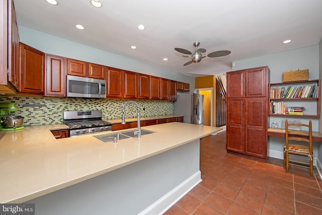 kitchen with light countertops, decorative backsplash, appliances with stainless steel finishes, a peninsula, and a sink