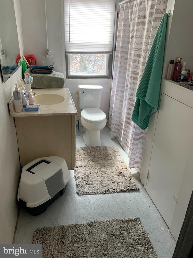 full bath with a shower with shower curtain, toilet, and vanity