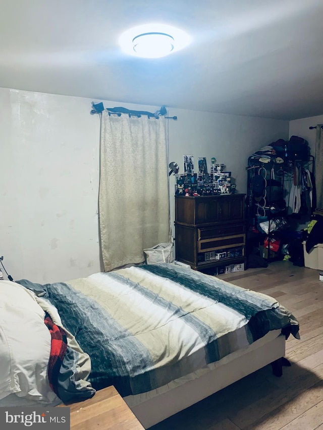 bedroom with wood finished floors