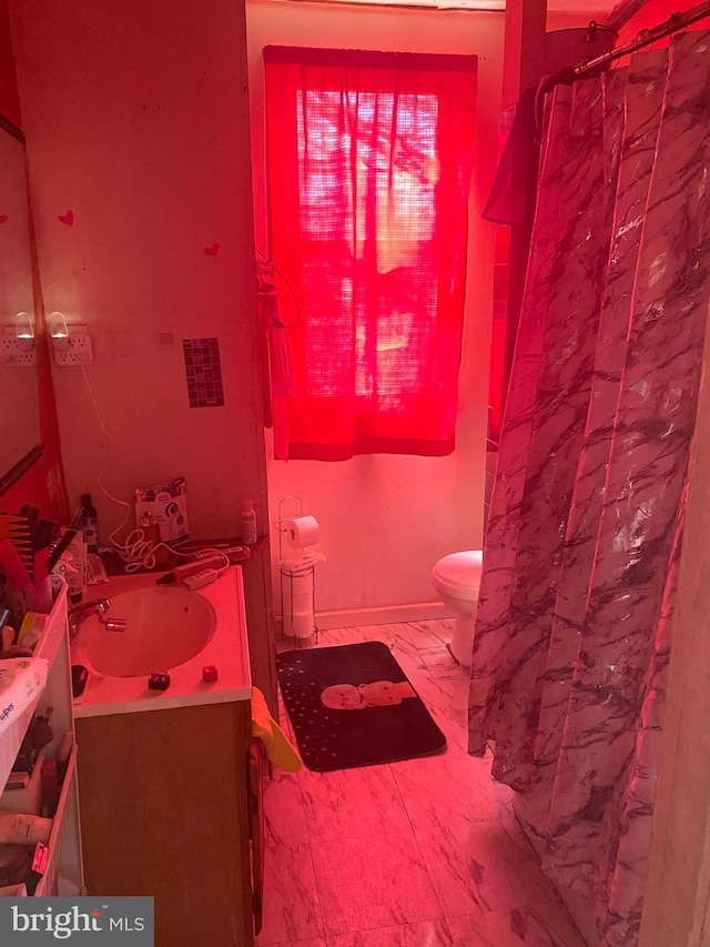 bathroom featuring marble finish floor, toilet, and vanity