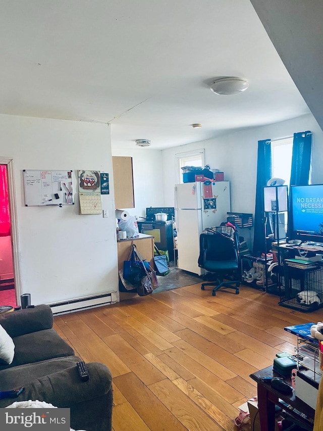 interior space with hardwood / wood-style floors and a baseboard heating unit