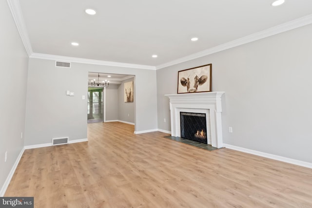 unfurnished living room featuring a chandelier, visible vents, crown molding, and a fireplace with flush hearth