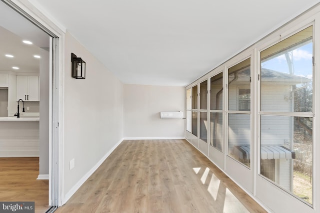 unfurnished sunroom featuring a sink