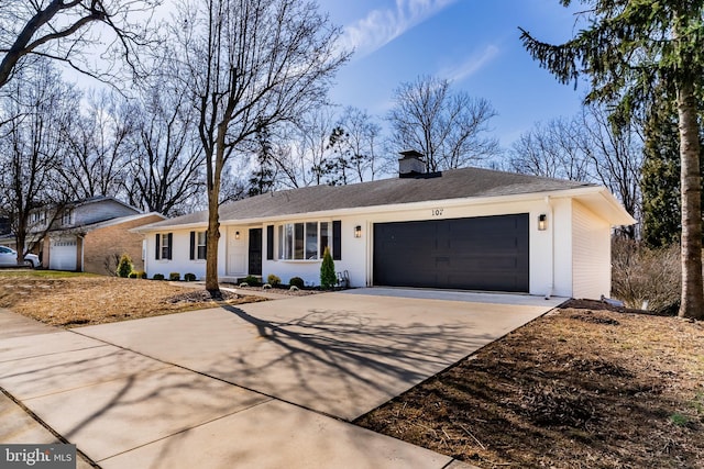 single story home featuring an attached garage, a chimney, and driveway