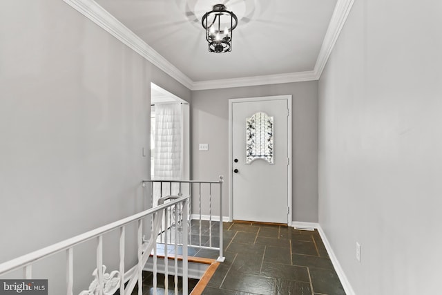 foyer entrance with baseboards, stone tile flooring, and crown molding