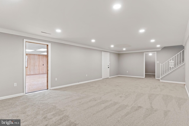 finished basement with recessed lighting, light colored carpet, and ornamental molding