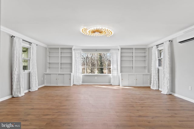 unfurnished living room featuring crown molding, wood finished floors, and baseboards