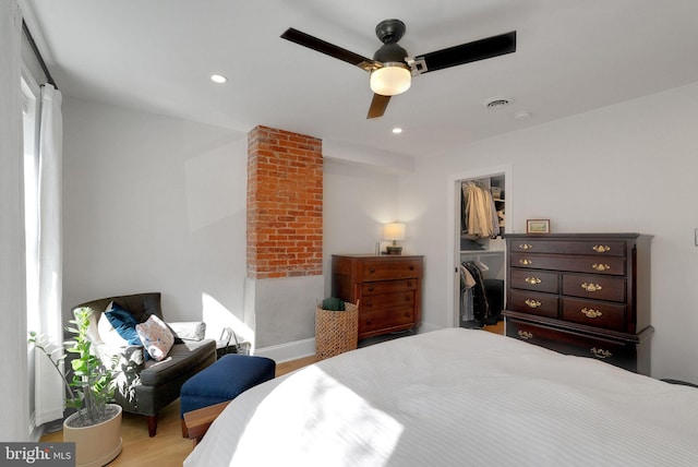 bedroom featuring wood finished floors, visible vents, recessed lighting, a closet, and a walk in closet