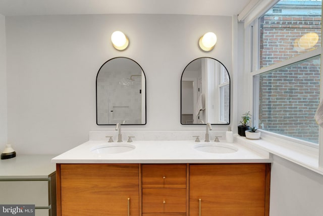 full bathroom featuring double vanity and a sink