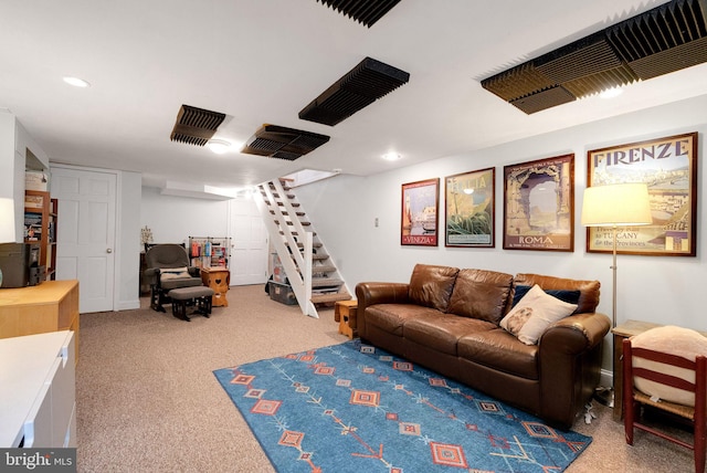 carpeted living room with stairway and recessed lighting