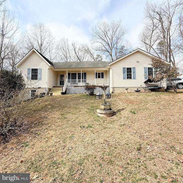 rear view of property with a porch, a yard, and crawl space