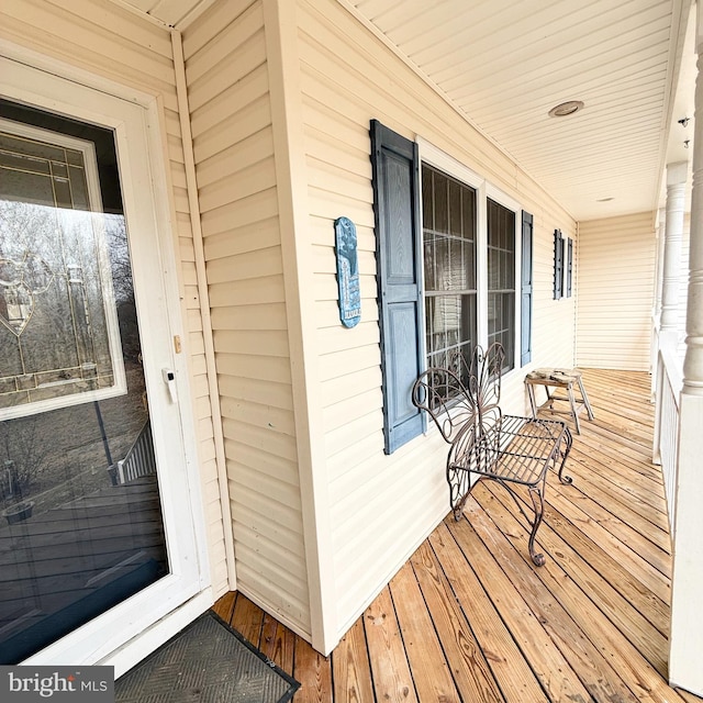 wooden terrace featuring covered porch