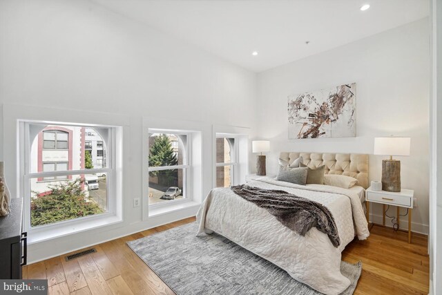 bedroom with recessed lighting, visible vents, multiple windows, and light wood finished floors