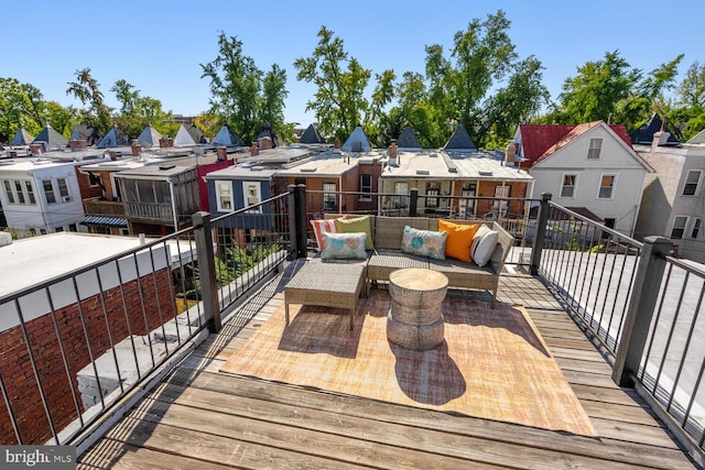 wooden deck with a residential view and an outdoor hangout area