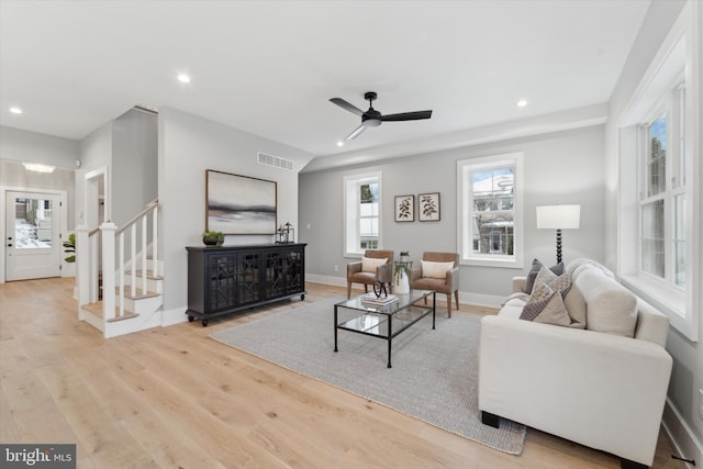 living area featuring visible vents, wood finished floors, recessed lighting, stairway, and baseboards