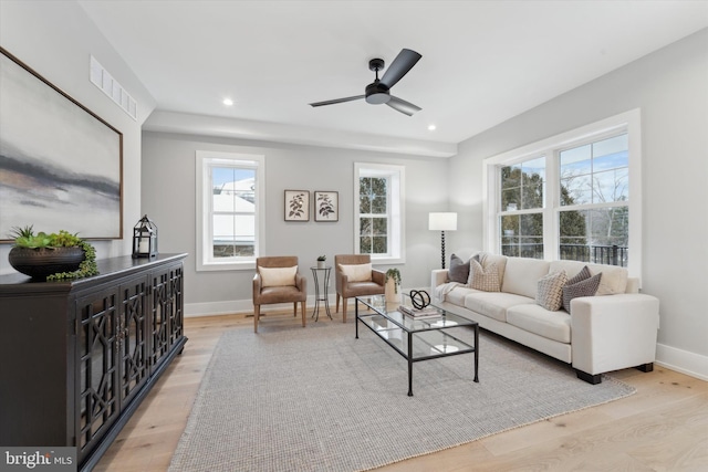 living area featuring recessed lighting, visible vents, baseboards, and light wood-style floors