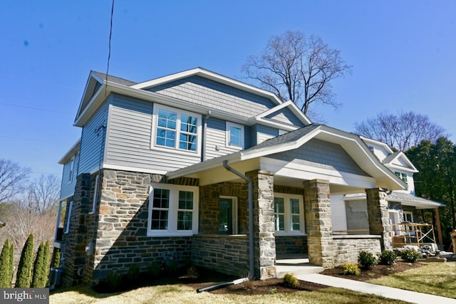 craftsman-style home featuring stone siding