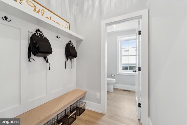 mudroom with visible vents, baseboards, and light wood-type flooring