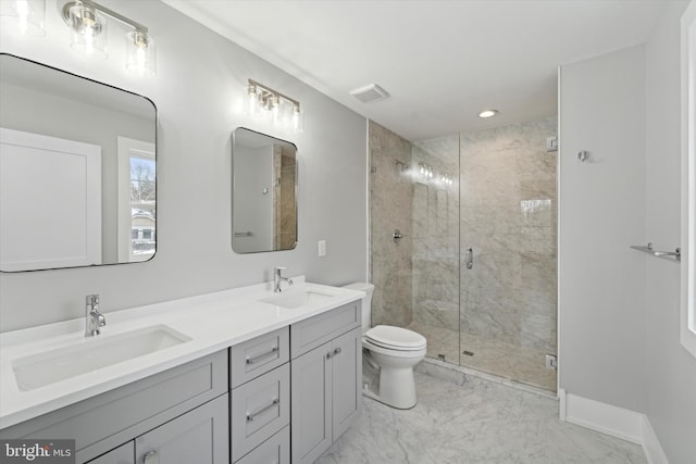 bathroom with a sink, toilet, marble finish floor, and a shower stall