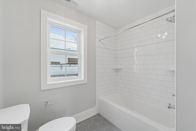 bathroom with visible vents, toilet, shower / tub combination, tile patterned flooring, and baseboards