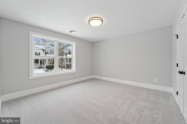 carpeted empty room with baseboards and visible vents