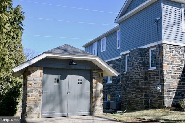 exterior space with stone siding and central AC unit