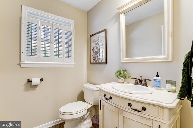 bathroom featuring toilet and vanity