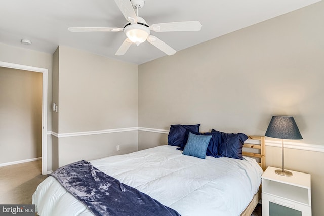 carpeted bedroom featuring baseboards and ceiling fan