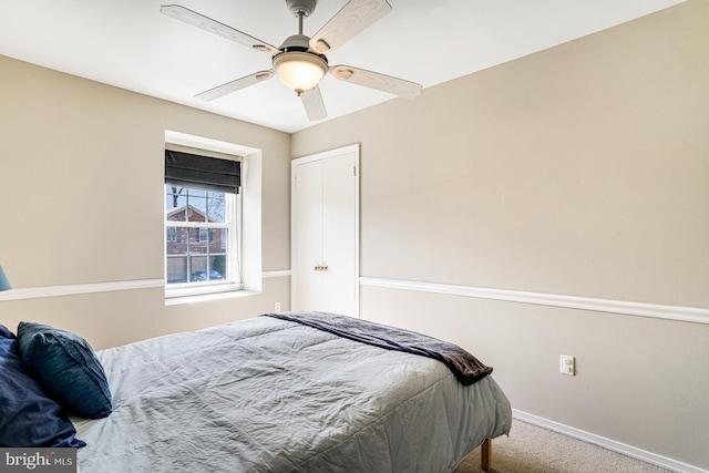 carpeted bedroom featuring baseboards and ceiling fan