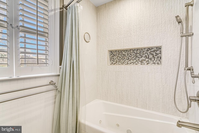 bathroom with a combined bath / shower with jetted tub