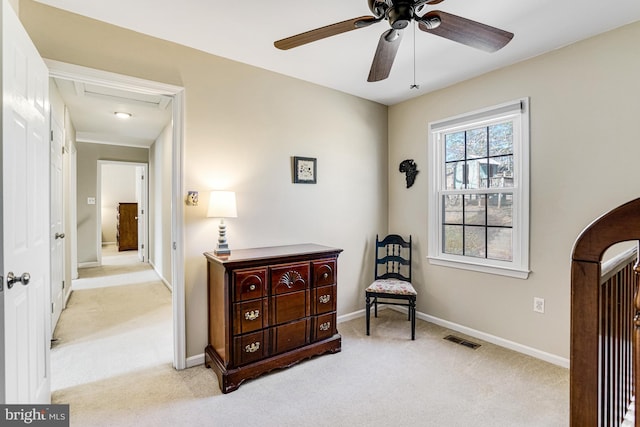 living area featuring arched walkways, visible vents, light colored carpet, and baseboards